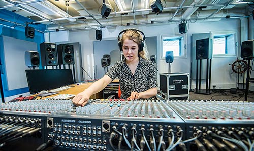 Female student at a mixing desk