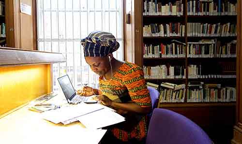 Woman working at desk in library